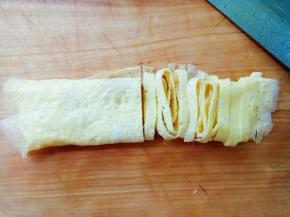 定型后，取出蛋饼皮，卷起切丝。