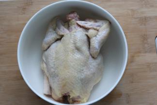 鸡放在一个大碗里，在全鸡表面涂上盐