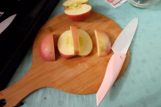 取其中一半苹果，中间留出约8mm，底部留出约5mm，用小号水果刀切出两块出来，这两块是用来做天鹅的翅膀的；