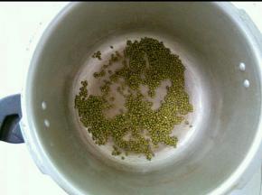 绿豆放入高压锅，小火煸炒至水分变干，再不断炒一会，至外皮略变色。