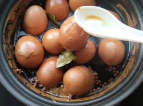 用勺子敲开蛋壳，来回翻一下，让它入味。