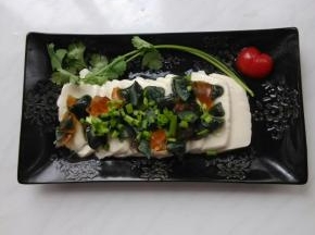 皮蛋碎放在豆腐上，撒上香葱末。