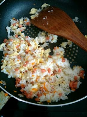 加入米饭和鸡蛋炒匀，加几滴宝宝酱油调味，再放少许葱花炒匀