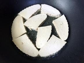 放入豆腐块煎制。