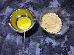 消化饼干放入料理机打成粉状，黄油隔水融化成液体，没有料理机的可以将饼干装入保鲜袋用擀面杖一点点擀碎。