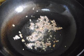 热锅，放入适量的油后爆香蒜末，放入猪肉翻炒变色