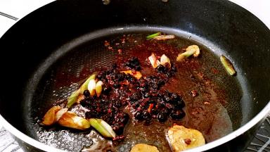 放入豆豉辣酱小火炒至出油。
