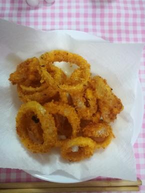 炸好的洋葱圈放在厨房纸上，吸去多余油。