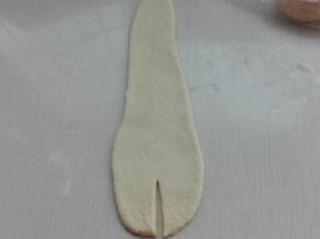 擀成如图所示，宽的一端切开一下