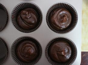 将面糊挤入纸杯模具中。七分满即可