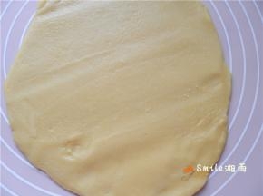 塔皮取出，待稍软后，在案板上铺点面粉，用面棍擀成6寸批萨盘大小。