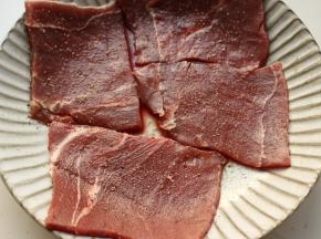 解冻好的牛肉撒海盐和现磨黑胡椒腌制10分钟。