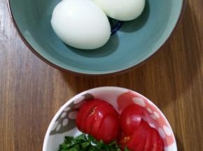 2、煮熟的鸡蛋去壳，番茄切片，香菜洗净切碎。