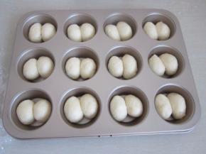 松弛好的面团稍稍整成椭圆形依次放入模具中。