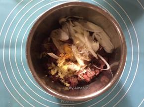 切好的牛肉片放入碗中，加入切片的葱白、老抽、生抽、白胡椒粉、白糖、香油、玉淀粉、料酒、姜末等调味料
