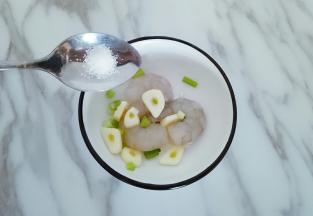 葱蒜切碎加入清水浸泡，放虾仁的碗中加入葱蒜，适量葱蒜水，加入盐腌制15分钟