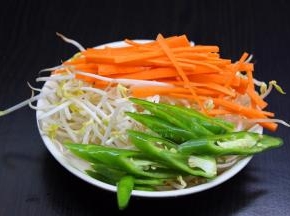 豆芽洗净，胡萝卜去皮切丝，辣椒洗净切好待用；