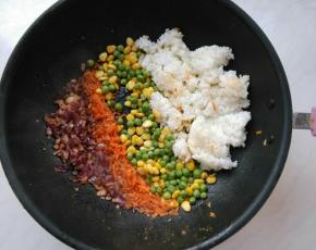 余油下姜末、洋葱粒炒香，再依次放入胡萝卜、青豆、玉米粒、米饭，翻炒均匀。
米饭下锅前，放入微波炉高火叮1分钟，这样米饭的水份蒸发一些，炒出来更干爽。