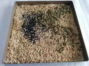 花生米，南瓜子仁，白芝麻，黑芝麻放入烤盘里面。