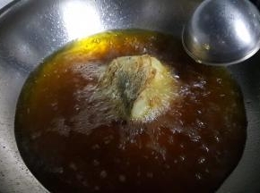 11.再将鱼头也炸成金黄色。