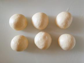 发酵好以后，用手轻拍排气然后分成六等分分别揉圆。盖保鲜膜醒发15分钟