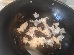 倒入黑木耳和银耳翻炒半分钟