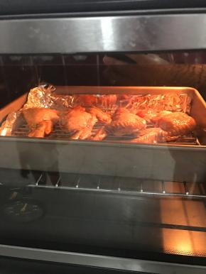 将弄好的鸡翅放入烤网上，放入烤盘中。鸡翅刷上一层烧烤酱（也可以刷原来的腌料）再刷上一层蜂蜜。
放入预热好的烤箱200度烤20分钟。