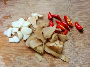 将大蒜、泡姜切片，泡椒切小段。