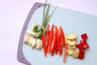 葱打结，红椒切丝、蒜瓣和姜切片，红尖椒切段