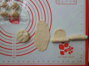 按扁，擀成牛舌状，自下向上卷起。