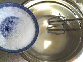 打发到蛋清泡沫细腻，再加入1/3的细砂糖，继续中高速打发