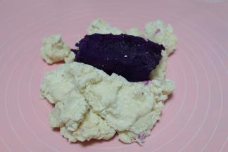 等面粉不烫手以后转移到揉面垫上，放上紫薯，紫薯是我之前蒸熟后预留的；