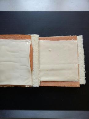 加上一片芝士，再把两片吐司叠加在一起，利用午餐肉的余温，融化芝士片