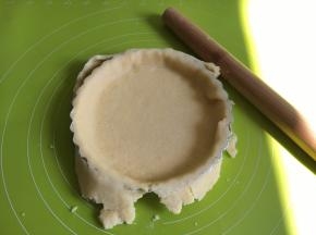 取出冷藏的面团，擀成比6寸派盘还要大的面皮，盖在派盘上