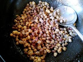 把前面炸好的花生倒入锅中，快速翻炒均匀关火。