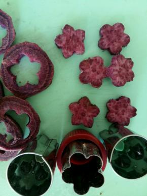 把紫薯切片，用模具压出花朵的形状。