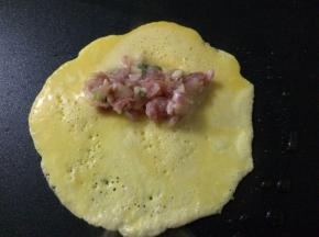 等蛋饼全部煎好后，将蛋饼对折起来，正好盖住肉泥