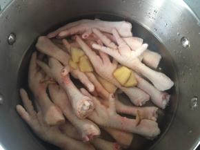 将鸡爪，姜，料酒倒入锅中，加没过鸡爪的水烧开后煮熟