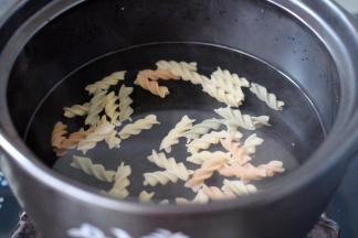 砂锅里加入适量清水、把螺旋意面放入锅中煮沸后、小火继续煮8分钟左右即可捞出用清水冲洗干净、沥干备用