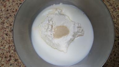 5．我们先来做福包，牛奶，发酵粉与中筋面粉，放在容器中。