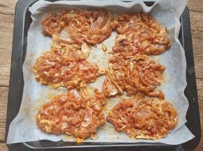 腌好的鸡腿肉放入铺了油纸的烤盘