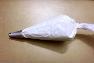 裱花袋装入裱花嘴，再把蛋白霜装入裱花袋中