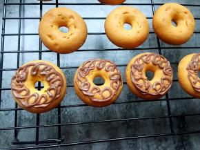 将巧克力液以画圈圈的方式涂在甜甜圈上面。