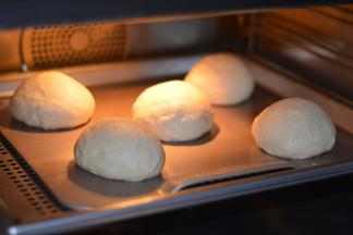 将发酵好的面团进行轻轻排出大气泡就可以了，然后分割，分成5等份，揉圆后进行第二次发酵，大概30分钟，两倍大。