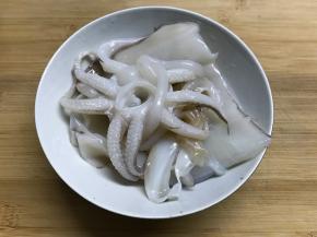 墨鱼买回来后剥去外面的黑衣，洗净。