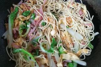 然后下入面条快速翻炒几下；