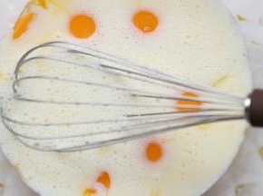 拌匀的色拉油牛奶倒入蛋黄中。