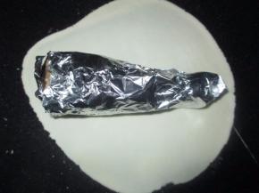 把面团擀成饼状，加入包好的鸡腿