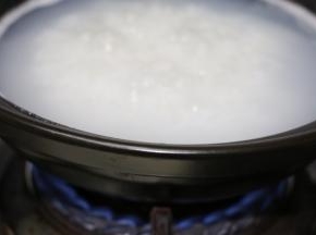 锅里放入适量的水，水烧开后下米，大火烧开转中小火熬煮