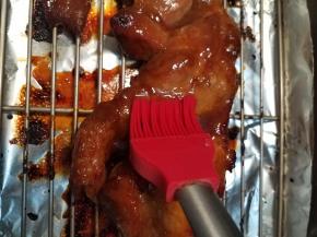 大约烘烤15分钟的时候，取出烤盘，再次给猪梅肉全身涂抹料汁，然后把猪梅肉翻个方向后放回烤箱继续烤制。